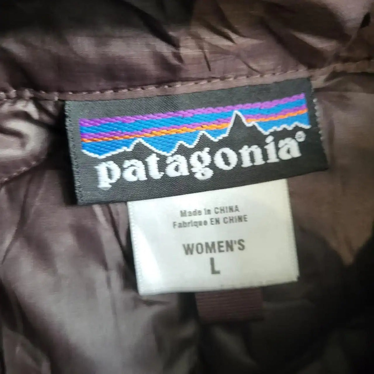 Manteau marron Patagonia femme taille L, étiquette visible. Fripes Sélect
