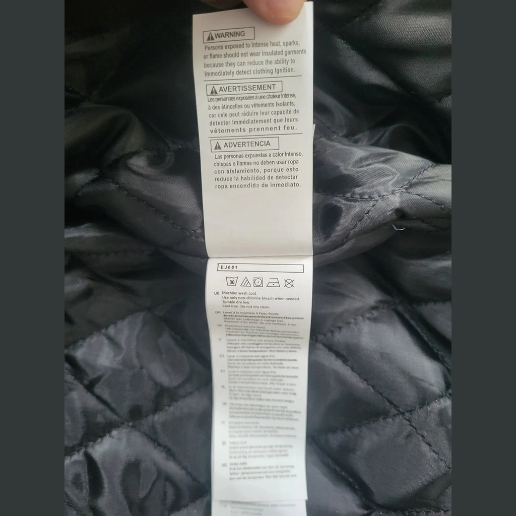 Veste noire matelassée Carhartt taille L, étiquette visible. Fripes Sélect