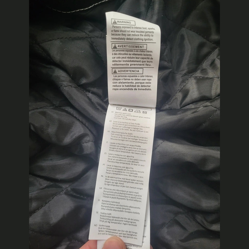 Étiquette intérieure montrant instructions d'entretien sur une veste matelassée noire taille M Fripes Sélect