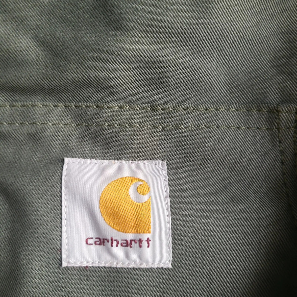 Veste Carhartt kaki taille M avec logo visible, Fripes Sélect