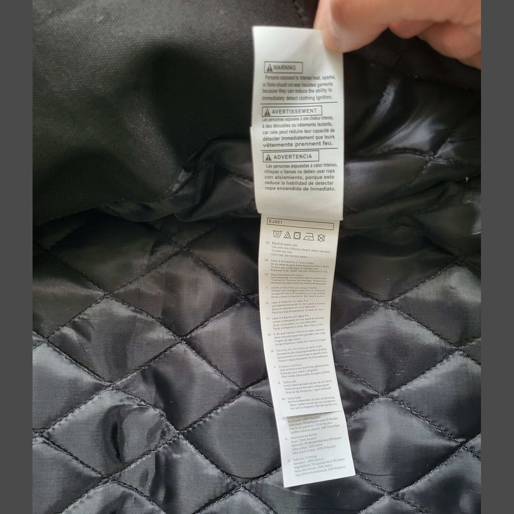 Veste Carhartt noire matelassée, taille M, étiquette visible. Fripes Sélect