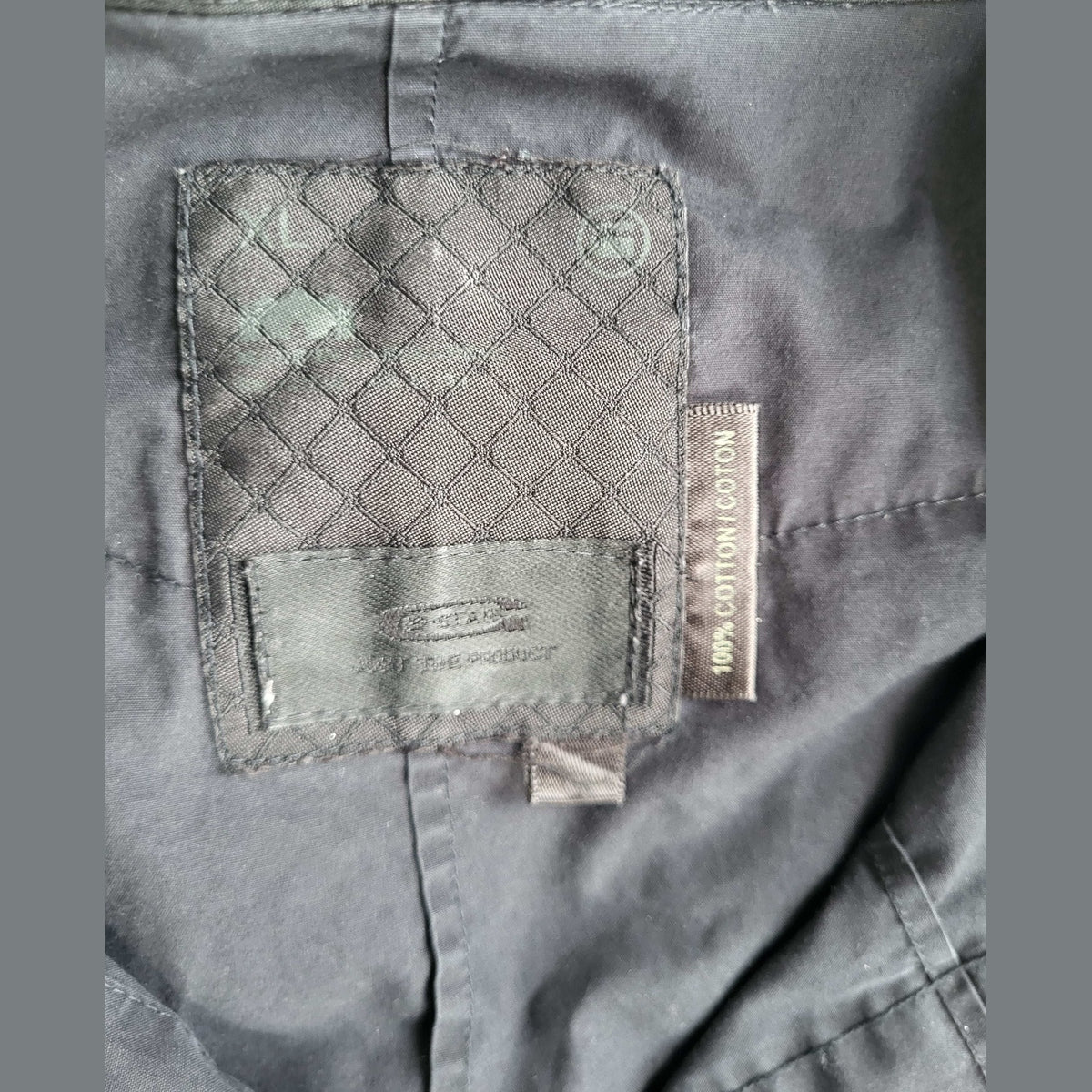 Veste noire, taille L, marque Stone Island visible sur l’étiquette, Fripes Sélect