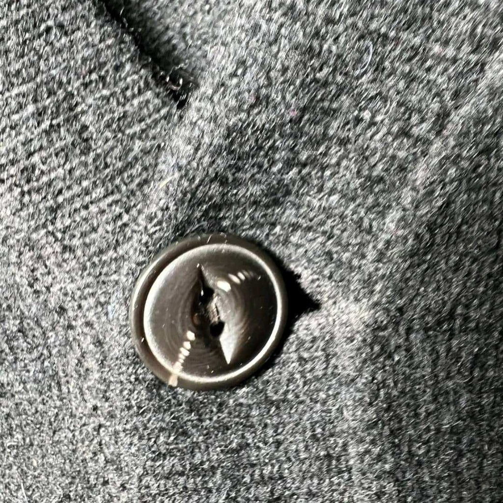 Manteau en laine gris foncé, bouton noir, taille non visible. Fripes Sélect