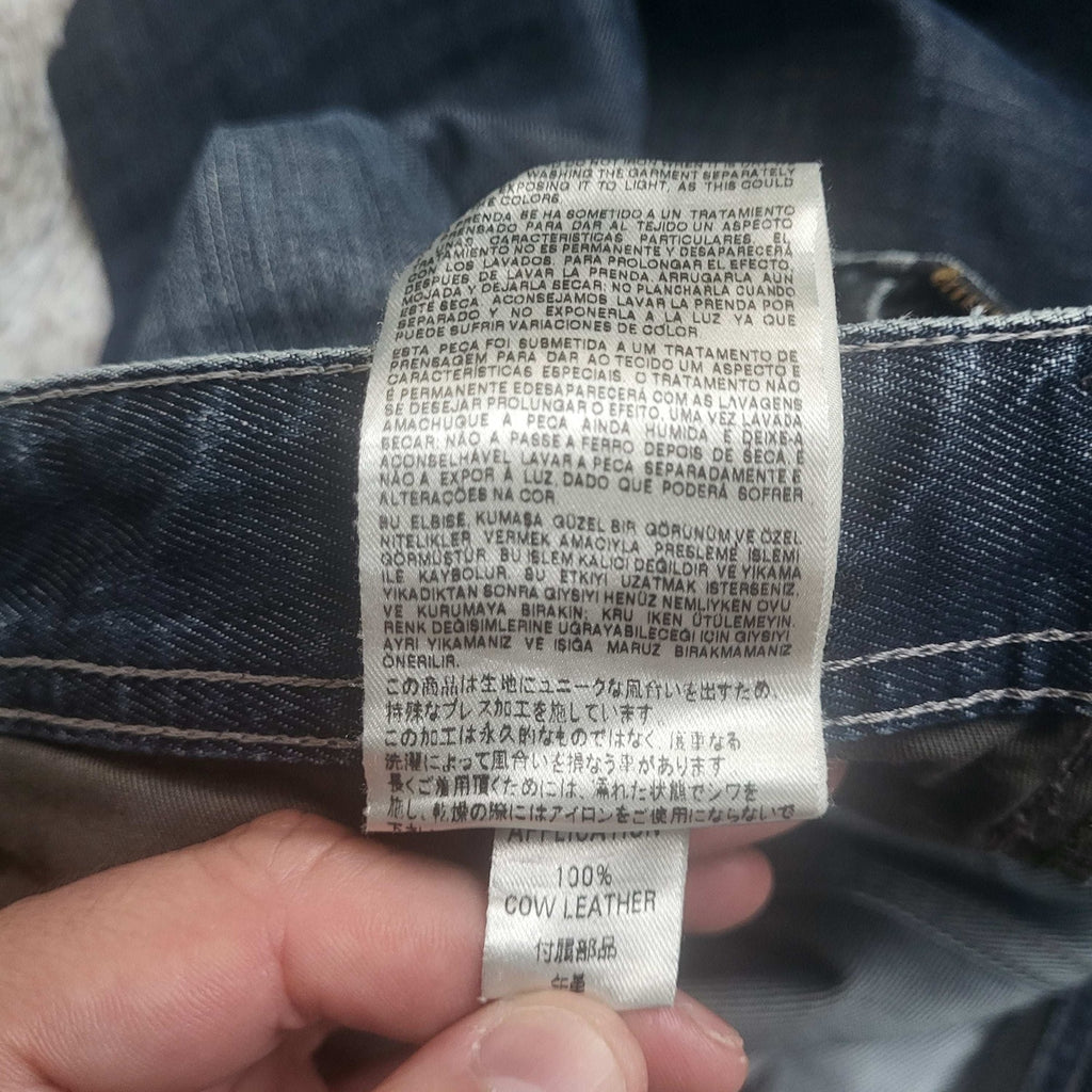 Jean bleu, marque non visible, taille non indiquée, détails cuir, Fripes Sélect
