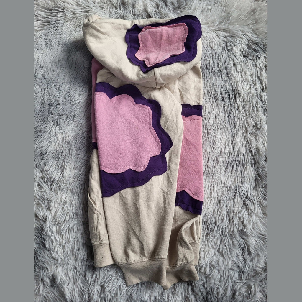 Sweat à capuche beige avec motifs roses et violets, taille non précisée. Fripes Sélect