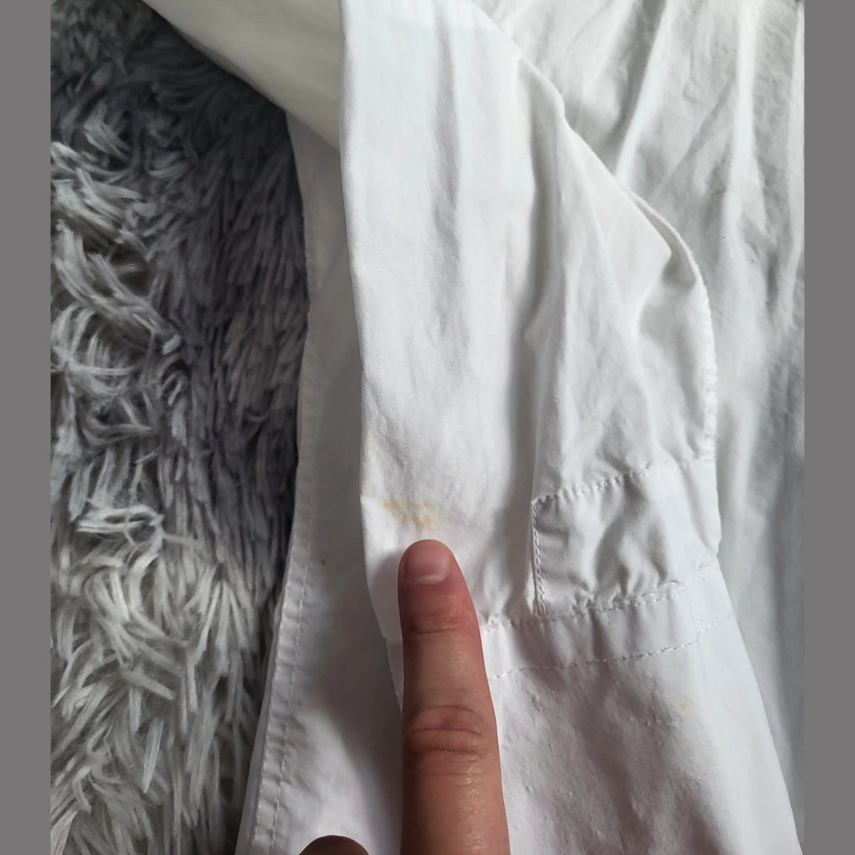 Chemise blanche, marque et taille non visibles, détail sur tache manche. Fripes Sélect