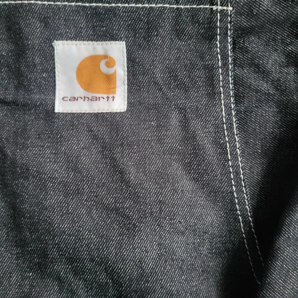 Pantalon en jean Carhartt noir, logo visible, taille non indiquée. Fripes Sélect