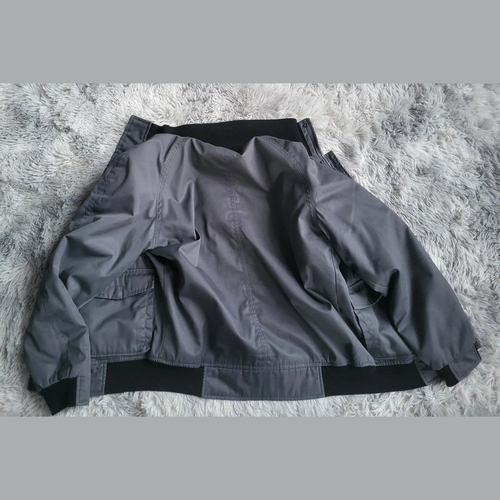 Veste grise unie sans marque apparente, taille non indiquée, Fripes Sélect