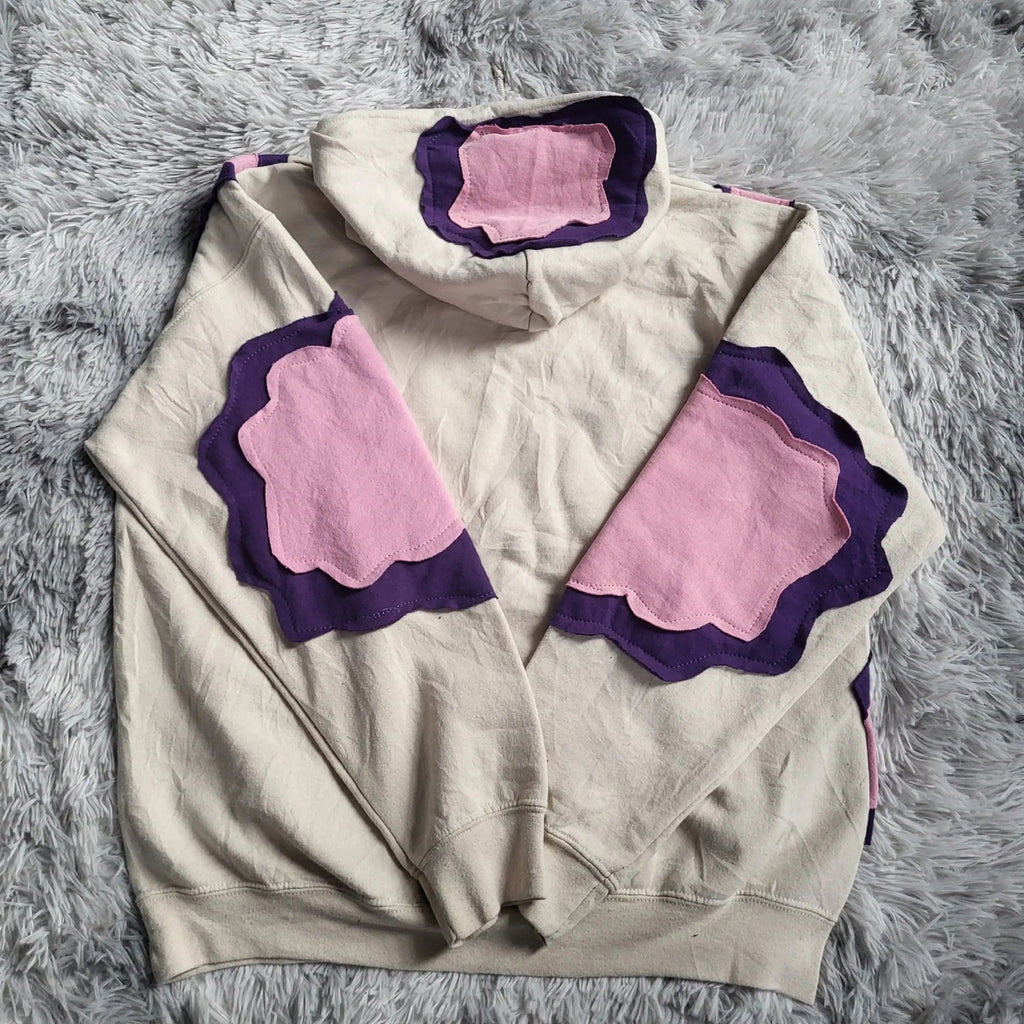 Sweat à capuche beige avec motifs violets et roses, taille non visible, Fripes Sélect