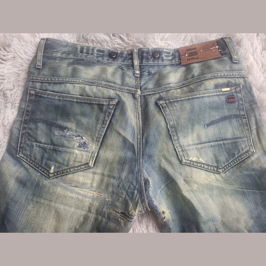 Jean bleu délavé G-Star RAW, taille 32, détails usés. Fripes Sélect