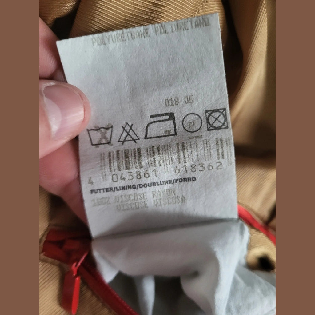 Étiquette d'entretien d'un vêtement beige, marque et taille non visibles. Fripes Sélect