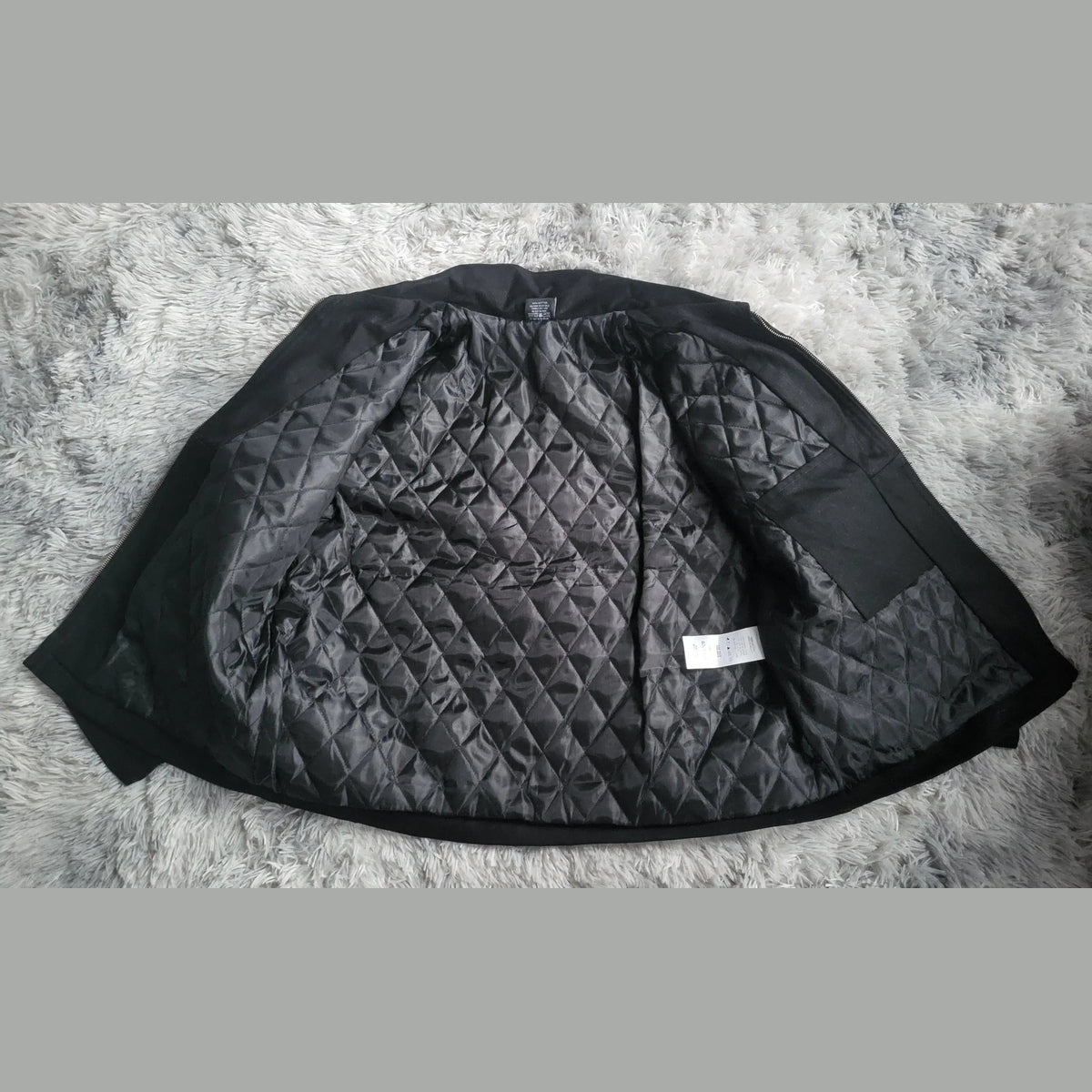 Veste matelassée noire, intérieur à losanges, taille XL, marque visible Fripes Sélect